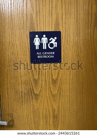 The entrance and sign to an all gender restroom.