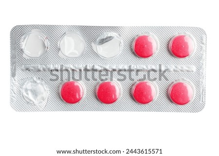 Red medicine pills in a blister pack isolated on white background, healthcare and medicine concept, top view. Royalty-Free Stock Photo #2443615571