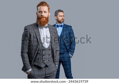 Tuxedo men wear menswear fashion. Elegant men in formalwear with bowtie. Two businessmen at business event. Tuxedo men in menswear isolated on grey. Tuxedo men in menswear. Copy space Royalty-Free Stock Photo #2443619739