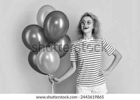 glad woman with birthday balloon in sunglasses. happy birthday woman hold party balloons