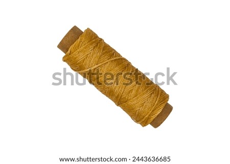 Spool with beige waxed threads isolated on transparent background.