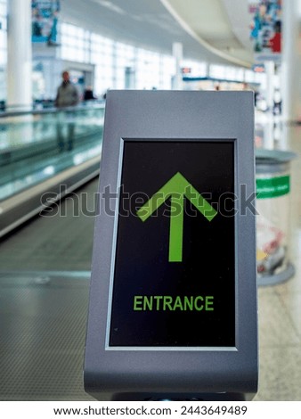 Green Digital Entrance Sign to a public escalator. Typically available in airports, subways and large shopping centers.