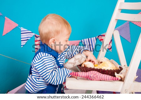 Child in blue with sea shells and decor