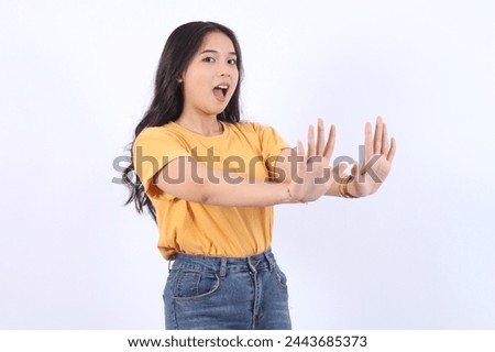 Stop. Concerned Asian woman showing refusal sign, saying no, raise awareness, standing over white background