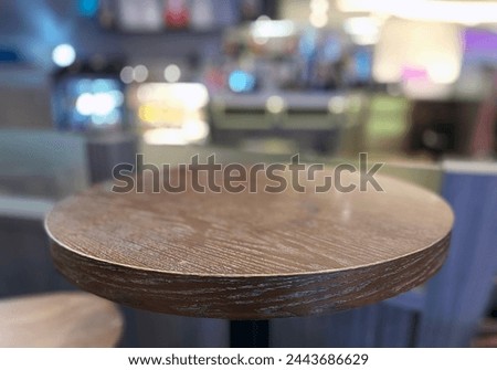 Interior photo visual view of an empty free place seat wood table for people to sit here and have a drink or snak or coffee drink beverage in a store shop take away area display round