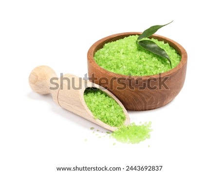 Green sea salt in bowl, scoop and leaves isolated on white