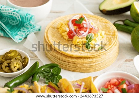 Stack of corn tortillas making breakfast tacos