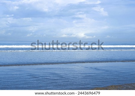 beautiful view of sea waves in a beach with blue sky and ocean water