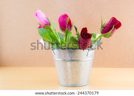 rose in aluminum pots  on brown background , valentine day
