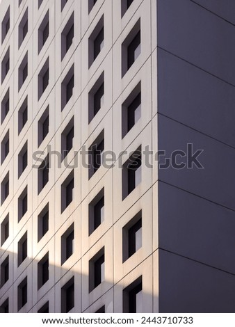 Bandung, Indonesia - March 29, 2024 : Windows viewed from low angle. Modern office architecture fragment with regular linear pattern of rectangles and parallel  Royalty-Free Stock Photo #2443710733