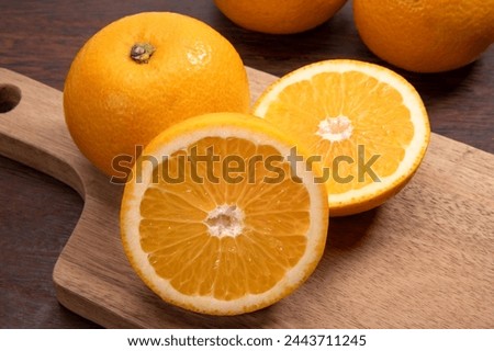 Japanese citrus hassaku on black background Royalty-Free Stock Photo #2443711245