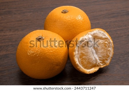 Japanese citrus hassaku on black background Royalty-Free Stock Photo #2443711247