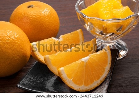 Japanese citrus hassaku on black background Royalty-Free Stock Photo #2443711249