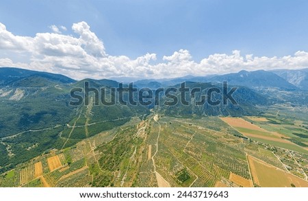 Lamia, Phthiotis, Greece. Panorama of the valley with fields. Olive trees, colorful fields. Summer, Cloudy weather. Aerial view