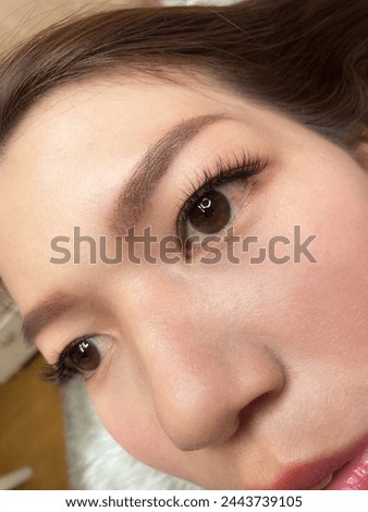 Eyelash extensions. Photo of a lovely woman after eyelash extensions. The eyelashes are clearly visible in the close-up photo. and pictures of half-breasted women