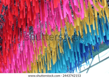 Picture colorful Ribbon  hang on ceiling out door of market place . This picture can use  for background and backdrop .
