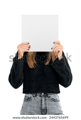 Young woman hiding face with mockup empty blank poster, isolated over white background. Concept of emotion, plan, idea, ad, announcement, marketing or sale