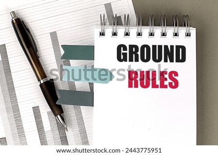 GROUND RULES text on notebook with chart on a gray background 