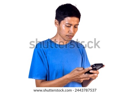 asian man in blue shirt looking at smartphone. white background