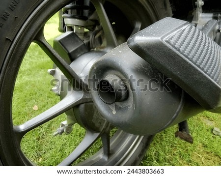 closeup photo of the back of a motorbike exhaust pipe.