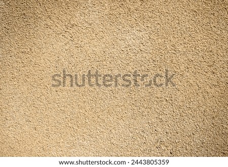 A sand beige colour stock photo of a newly plastered wall