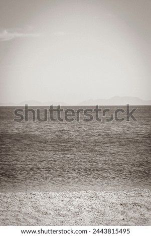 Old black and white picture of the most beautiful beaches on Kos Island in Greece with panorama view on hills and islands.
