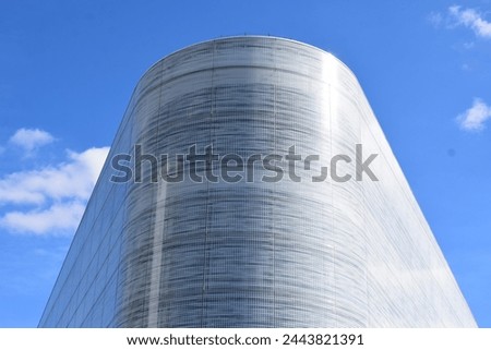 tall white building with a round corner
