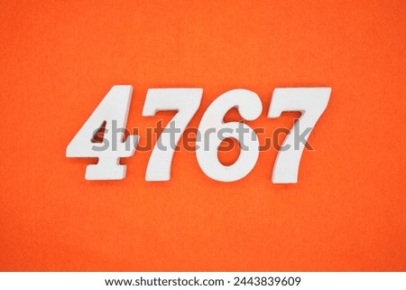 Orange felt is the background. The numbers 4767 are made from white painted wood.