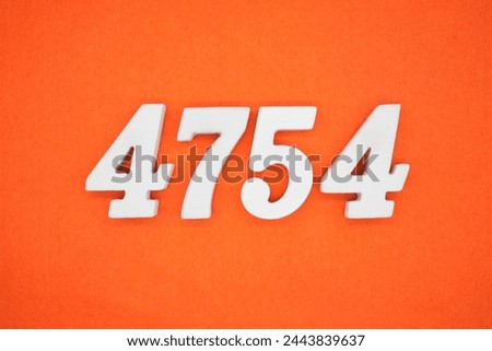 Orange felt is the background. The numbers 4754 are made from white painted wood.