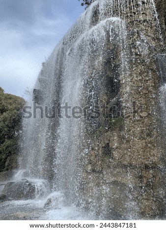 Artificial Waterfall at Castle Hill (Colline du Chateau) park. Running water. It is a very popular sightseeing and recreation place. Nice, Cote d'Azur, France Royalty-Free Stock Photo #2443847181