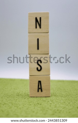NISA letter block placed on a green carpet