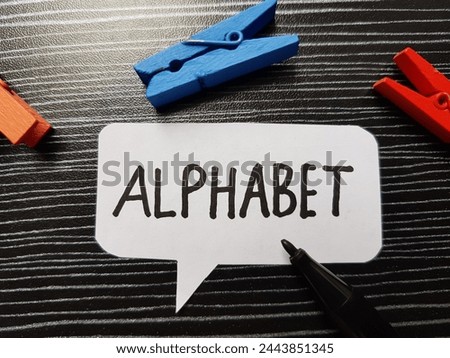Alphabet writting on table background.