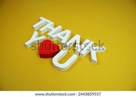 Thank You alphabet letters top view on yellow background
