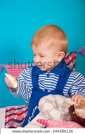 Child in blue with sea shells and decor