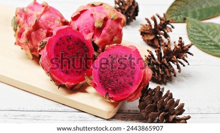 Fresh red dragon fruits (pitaya) with purplish red flesh and black seeds. The cactus-like fruit is sweet and rich in betalains that gives the vibrant color. Royalty-Free Stock Photo #2443865907