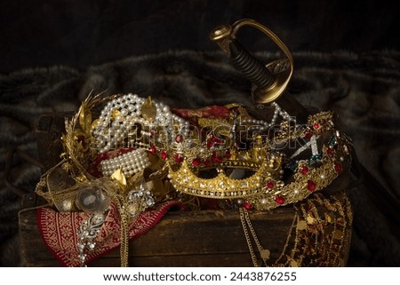 Romantic image of a treasure chest filled with jewellery, precious gems and golden king's crowns Royalty-Free Stock Photo #2443876255