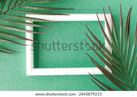 White photo frame on green glitter background with pattern. Modern template for designer