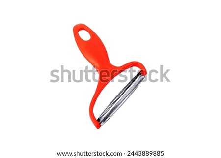 Slicing potatoes. Potato peeler. on a white isolated background. Slicer. Professional vegetable peeler for chefs with a sharp knife or stainless steel blade. Kitchen utensils for the kitchen.
