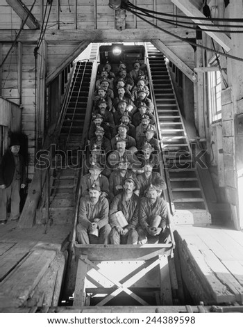 Miners in an open tram at the Calumet and Hecla Mining Company, one of the largest and most profitable copper mines in American in the late 19th and early 20th century, employing 5000 people. 1906.