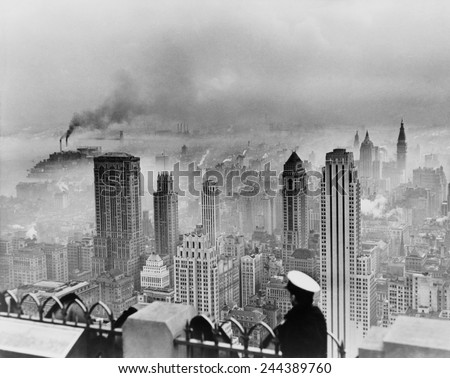 New York City under smog when weather conditions prevented smoke from dispersing. View from the Empire State Building includes the Lincoln Building and RCA Building. 1949 photo by Edward Ratcliffe.