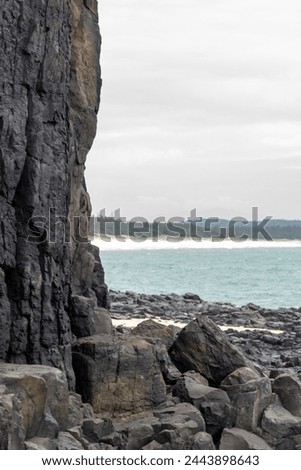 A view of the blue sea and distant islands peeking out from a corner at Ganh Den lighthouse in Phu Yen. Royalty-Free Stock Photo #2443898643