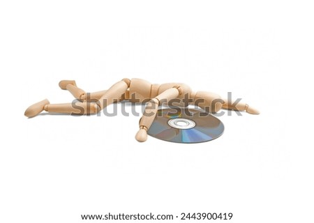 wood mannequin with CD-rom on white background Royalty-Free Stock Photo #2443900419
