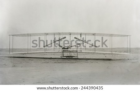 The Wright Brothers 'machine' the plane in which they made the first powered controlled flight in a heavier-than-air airplane on December 17 1903. Royalty-Free Stock Photo #244390435