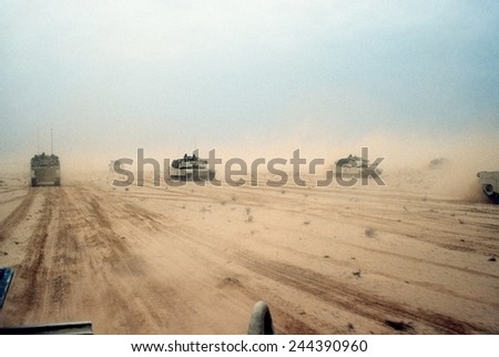 Abrams tanks of the 1st Armored Division 7th Corps move across the desert in northern Kuwait during Operation Desert Storm. Feb. 28 1991. Royalty-Free Stock Photo #244390960