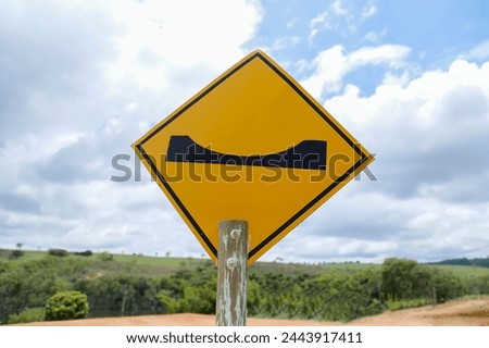yellow traffic sign indicating depression ahead - warning and danger signs on the road