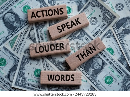 Actions speak louder than Words symbol. Wooden blocks with words Actions speak louder than Words. Beautiful dollar background. Business and Actions concept. Copy space.