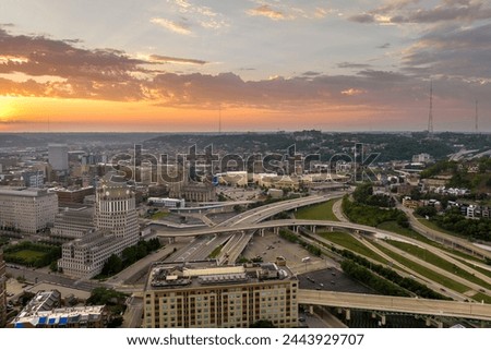 Aerial view of American highway junction at sunset with fast driving vehicles in Cincinnati city, Ohio. View from above of USA transportation infrastructure