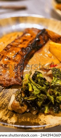 New york strip loin beef steak meat with mushroom sauce and potato wedges and salad plated on beautiful plate on a steak house
