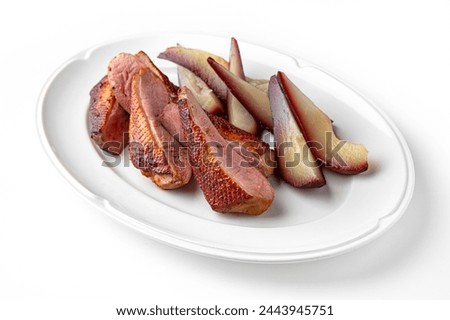 Duck fillet baked with pear in wine on a white plate. Banquet festive dishes. Gourmet restaurant menu. White background.