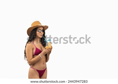 copyspace Beautiful Latin woman relaxes on the beach, sipping a tropical cocktail and wearing a stylish sun hat, epitomizing the essence of a perfect summer getaway on white background Royalty-Free Stock Photo #2443947283